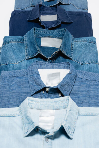 close up view of different denim shirts isolated on white