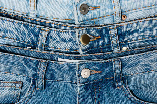 close up view of various blue jeans