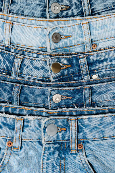 close up view of various blue jeans 