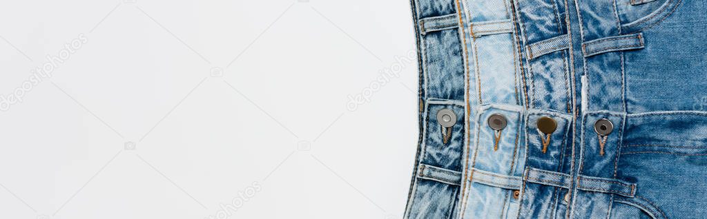 top view of various blue jeans isolated on white with copy space, banner