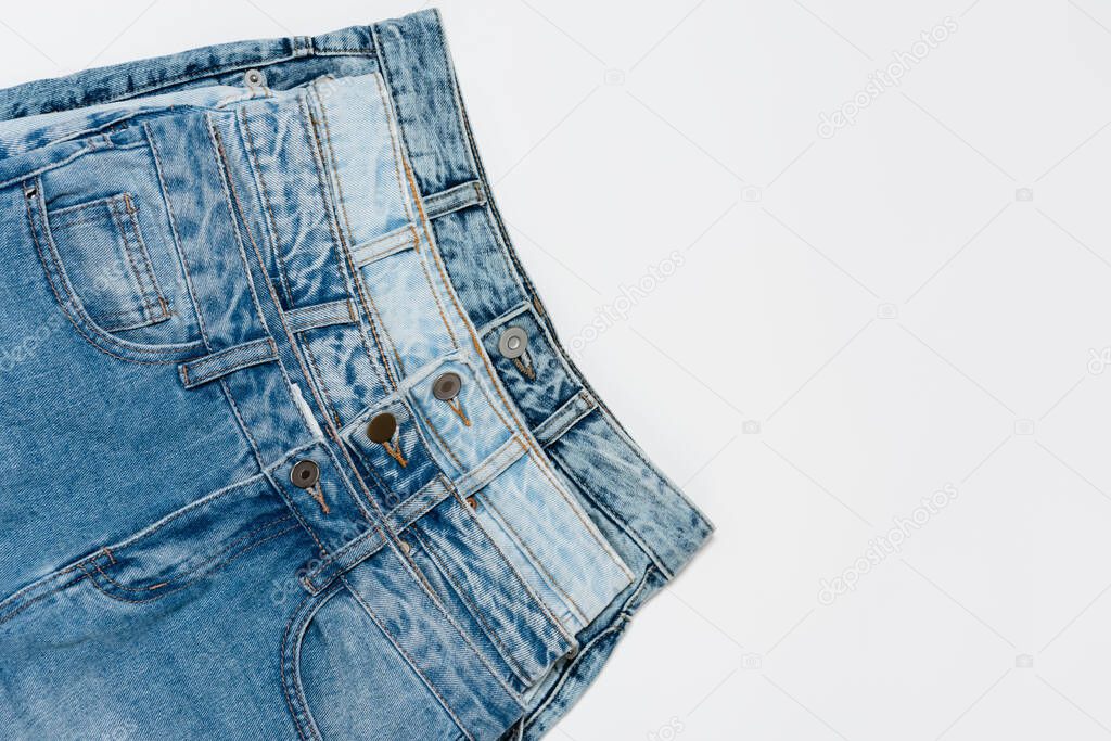 top view of various denim jeans on white background 