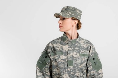 Soldier in uniform looking away isolated on grey  clipart