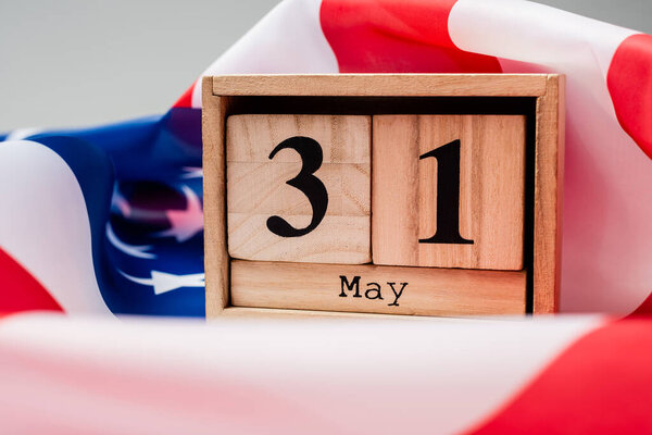 Close up view of calendar with 31 may date on american flag on grey background 
