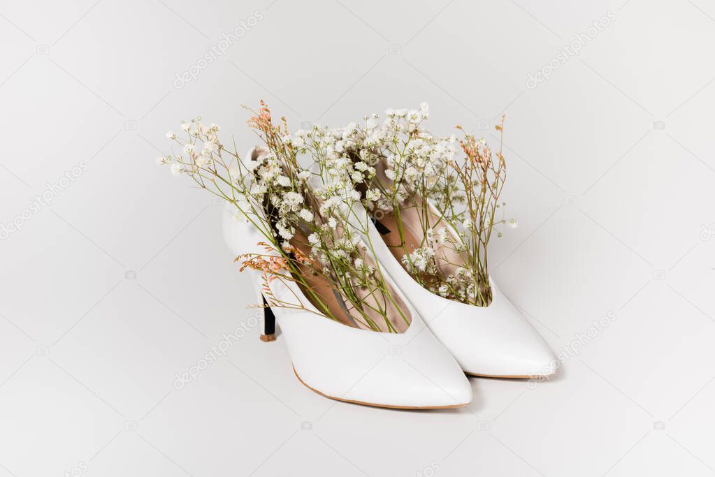 heeled shoes with tiny gypsophila flowers on white 