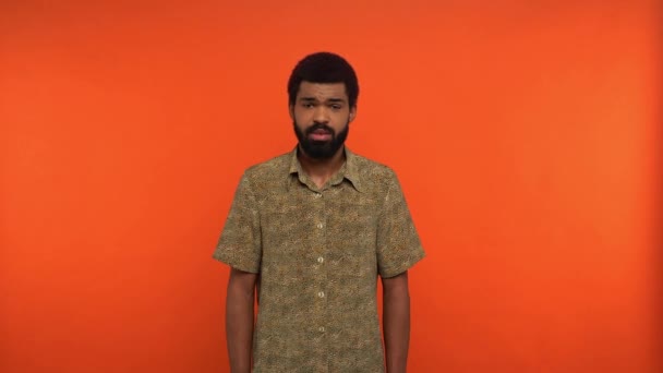 Displeased Bearded African American Man Talking Isolated Orange — Stock Video