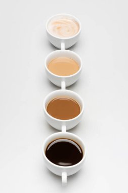 different prepared coffee drinks with milk on white clipart