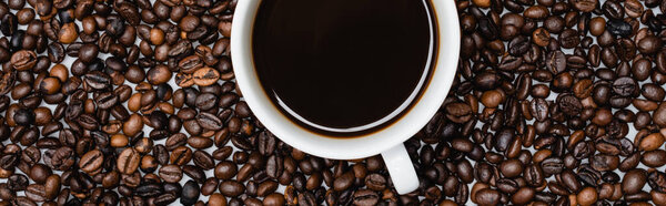 top view of cup with americano on coffee beans, banner