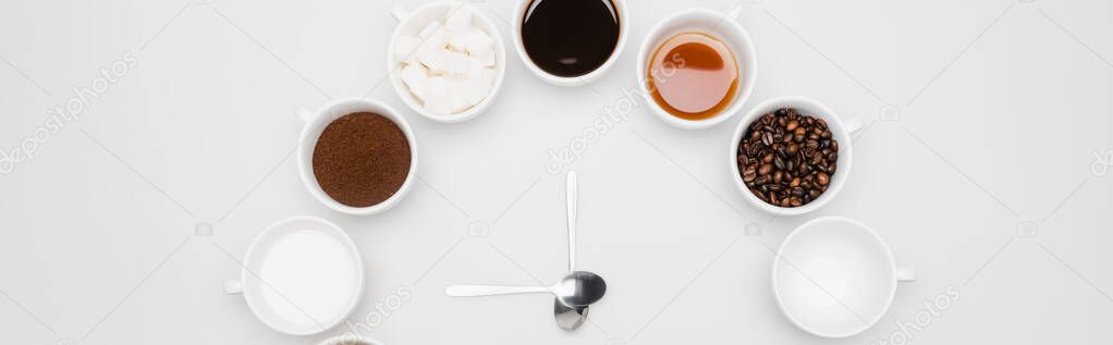 top view of black coffee in cups near beans and sugar cubes on white, banner