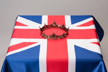 luxury royal crown on union jack flag isolated on grey clipart