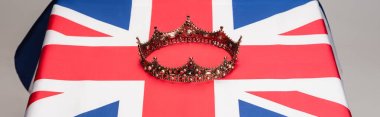 golden royal crown on british flag isolated on grey, banner clipart