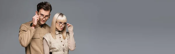 Stylish Models Adjusting Glasses Posing Isolated Grey Banner — Stock Photo, Image