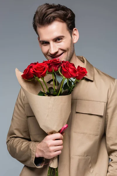 Joyful Man Holding Bouquet Red Roses Isolated Grey — Stock Photo, Image