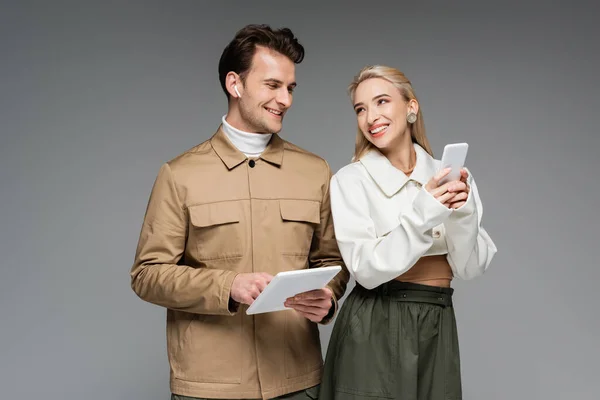 Happy Woman Holding Smartphone Man Digital Tablet Isolated Grey — Stock Photo, Image