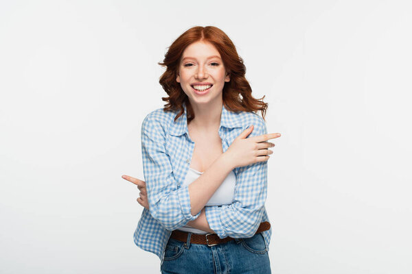 satisfied redhead woman in blue plaid shirt isolated on white