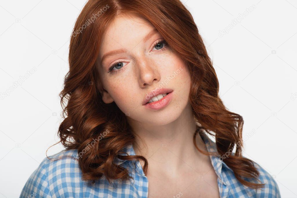 redhead woman in blue plaid shirt looking at camera isolated on white