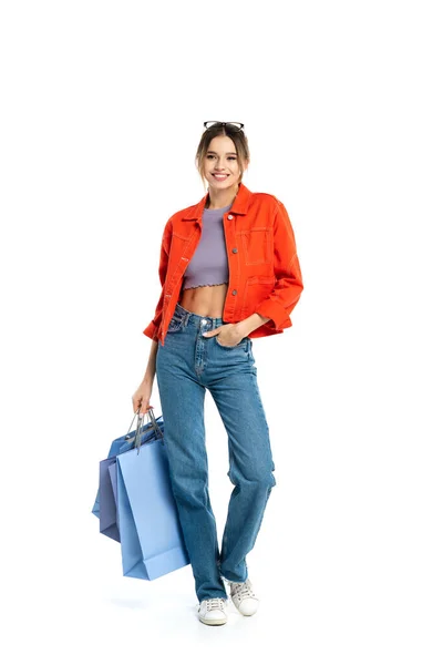 Full Length Happy Woman Orange Shirt Holding Shopping Bags While — Stock Photo, Image