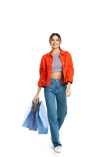 Full Length Happy Woman Orange Shirt Holding Shopping Bags Walking — Stock Photo, Image