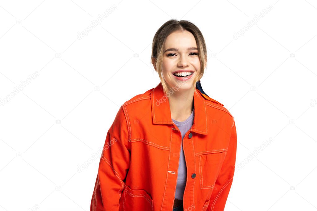 joyful young woman in orange shirt smiling isolated on white 