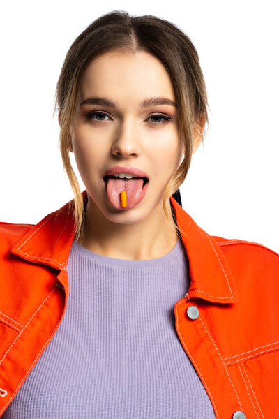 young woman sticking out tongue with capsule isolated on white 