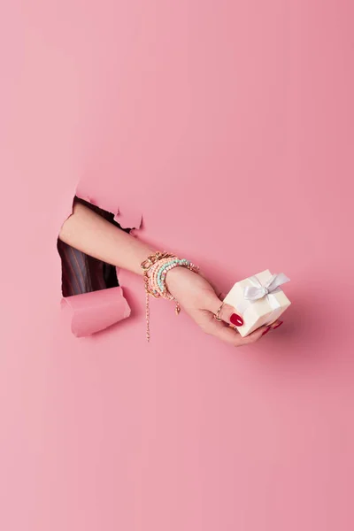 Cropped View Young Woman Holding Present Pink Background Hole — Stock Photo, Image