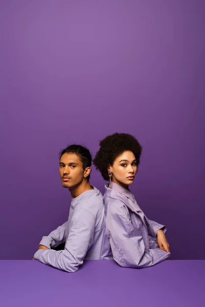 Fashionable African American Couple Sitting Back Back Isolated Purple — Stock Photo, Image