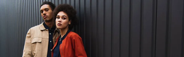 African American Man Looking Camera While Posing Curly Woman Orange — Stok Foto