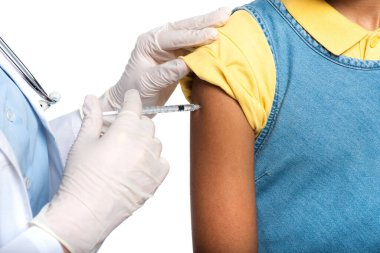 Cropped view of doctor in latex gloves doing vaccination of african american child isolated on white  clipart