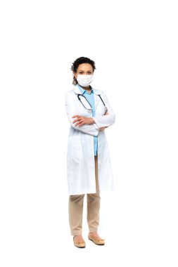 African american doctor in medical mask standing with crossed arms on white background  clipart