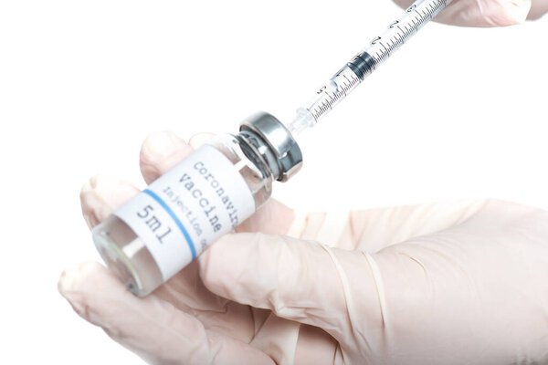 Cropped view of syringe and jar with coronavirus vaccine in hands of doctor isolated on white 