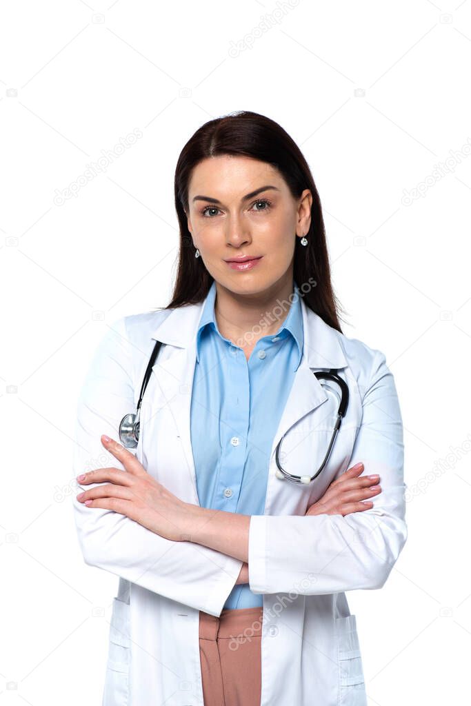 Brunette doctor with stethoscope looking at camera isolated on white 