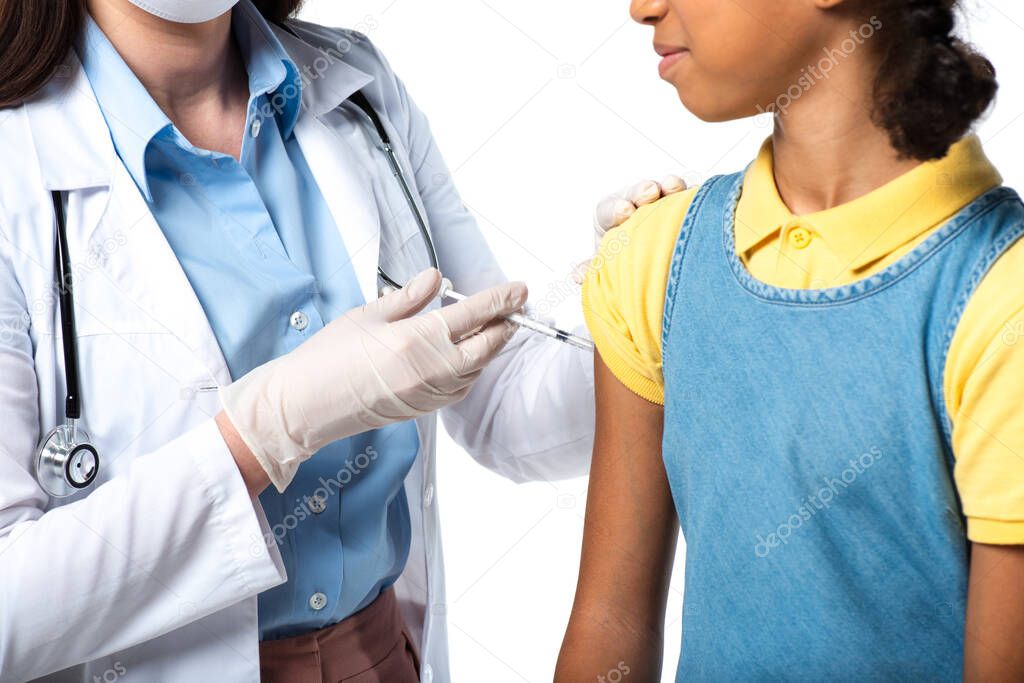 Cropped view of pediatrician doing vaccine injection to african american kid isolated on white 