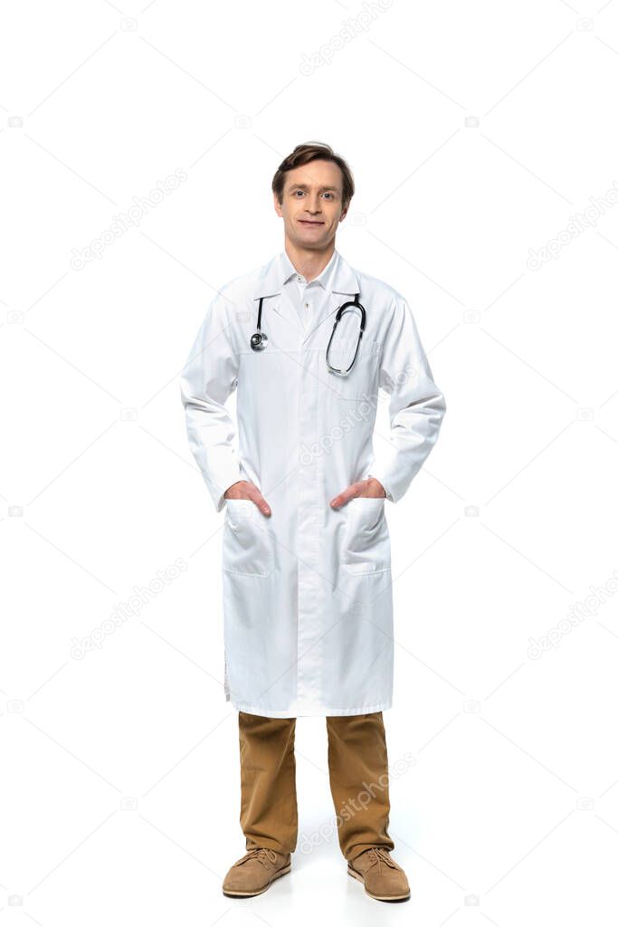 Doctor in white coat looking at camera on white background 