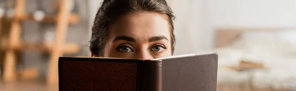 Mujer Oscureciendo Cara Mientras Sostiene Libro Mirando Cámara Pancarta —  Fotos de Stock