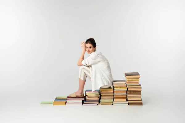 Full Length Smiling Young Woman Sandals Sitting Pile Books White — Stock Photo, Image