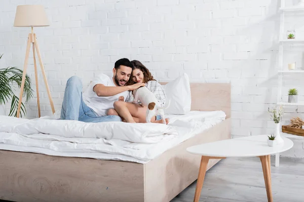 Pleased Interracial Couple Cuddling Jack Russell Terrier Bedroom — Stock Photo, Image