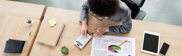 Overhead View African American Manager Using Calculator Devices Table Banner — Stock Photo, Image