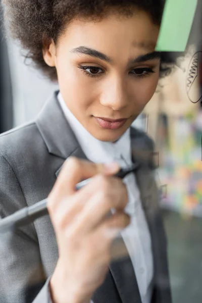 African American Businesswoman Drawing Blurred Glass Board — Stock Photo, Image