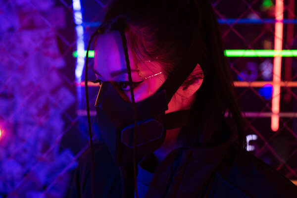 lighting on young asian woman in gas mask 