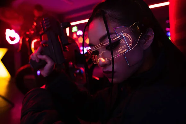 Armed Asian Woman Sunglasses Holding Blurred Gun — Stockfoto