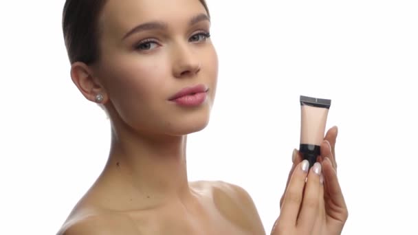 Slow Motion Young Woman Holding Face Foundation Isolated White — Stock Video