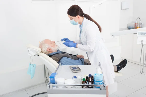 Стоматолог Вивчає Зуби Старшого Чоловіка Зондом Дзеркалом Стоматологічній Клініці — стокове фото