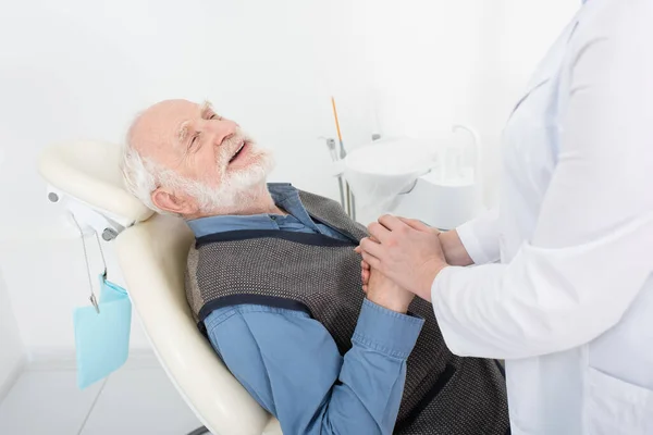 Smiling Senior Patient Lying Dental Chair Holding Hands Dentist Clinic — Stock Photo, Image