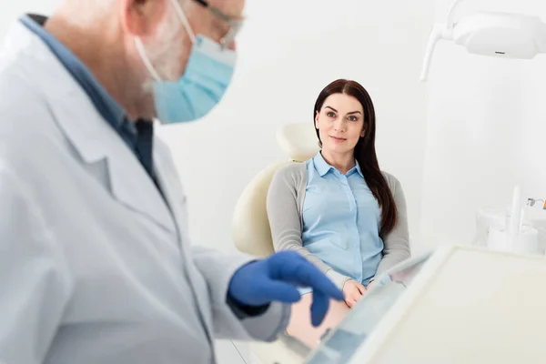 Positive Woman Sitting Dental Chair Looking Dentist Standing Equipment Clinic — 스톡 사진