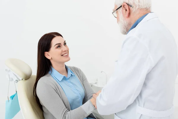 Smiling Patient Dental Chair Holding Hands Senior Doctor Clinic — Stock Photo, Image