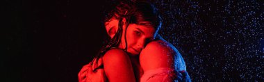 wet passionate romantic couple in water drops in red and blue colors filters on black background, banner clipart