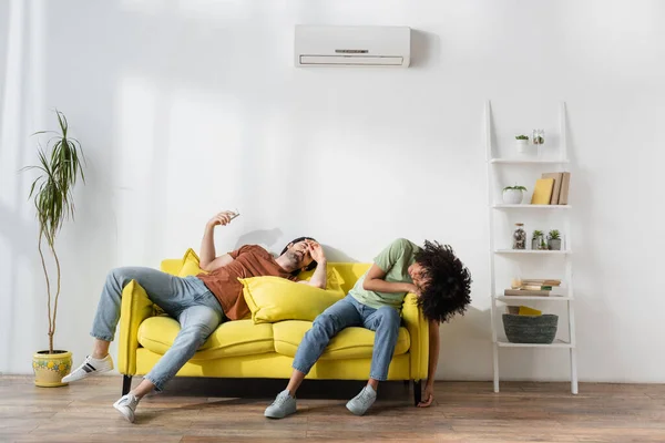 Interracial Couple Suffering Heat Yellow Couch Modern Living Room — Stock Photo, Image