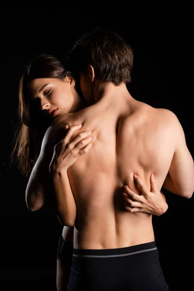 Seductive Woman Passionately Hugging Man Muscular Back Isolated Black Royalty Free Stock Photos