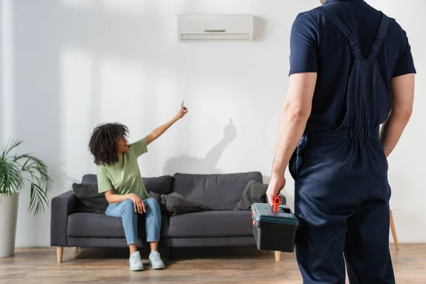 Blurred African American Woman Pointing Broken Air Conditioner Handyman Toolbox — Stock Photo, Image