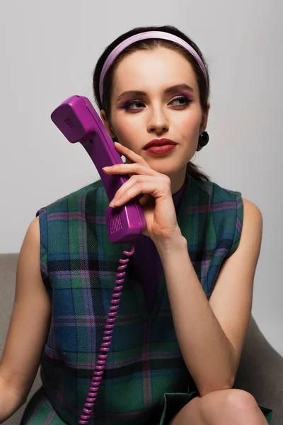 Brunetka Mladá Žena Drží Retro Telefon Zatímco Dívá Jinam Sedí — Stock fotografie