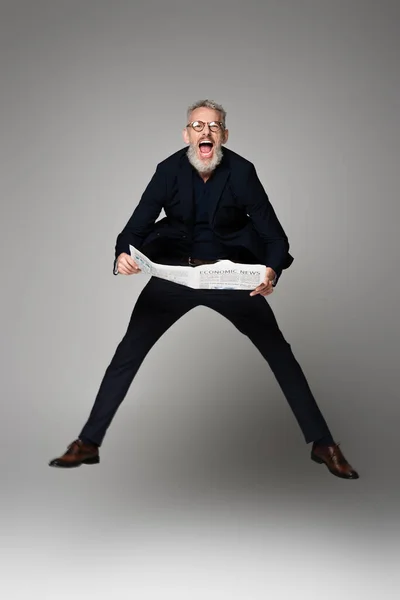 Full Length Amazed Man Glasses Suit Holding Newspaper While Levitating — Stock Photo, Image